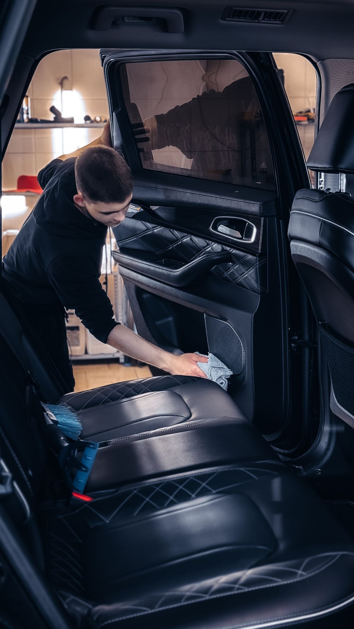 Мастер очищает обивку автомобиля